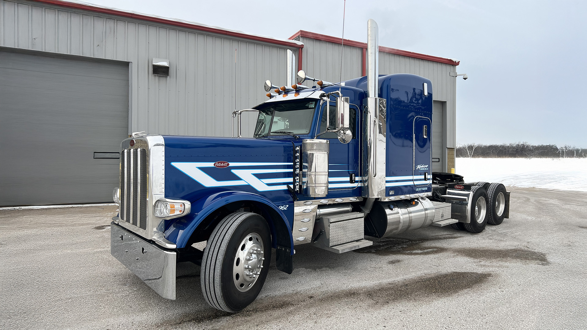 JX Graphics custom truck blue Peterbilt with white striping