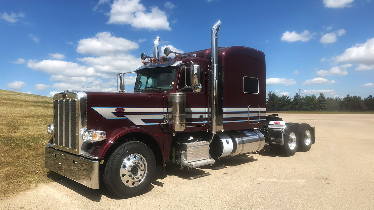JX Graphics on black cherry Peterbilt paint with gradient white, blue & gray striping