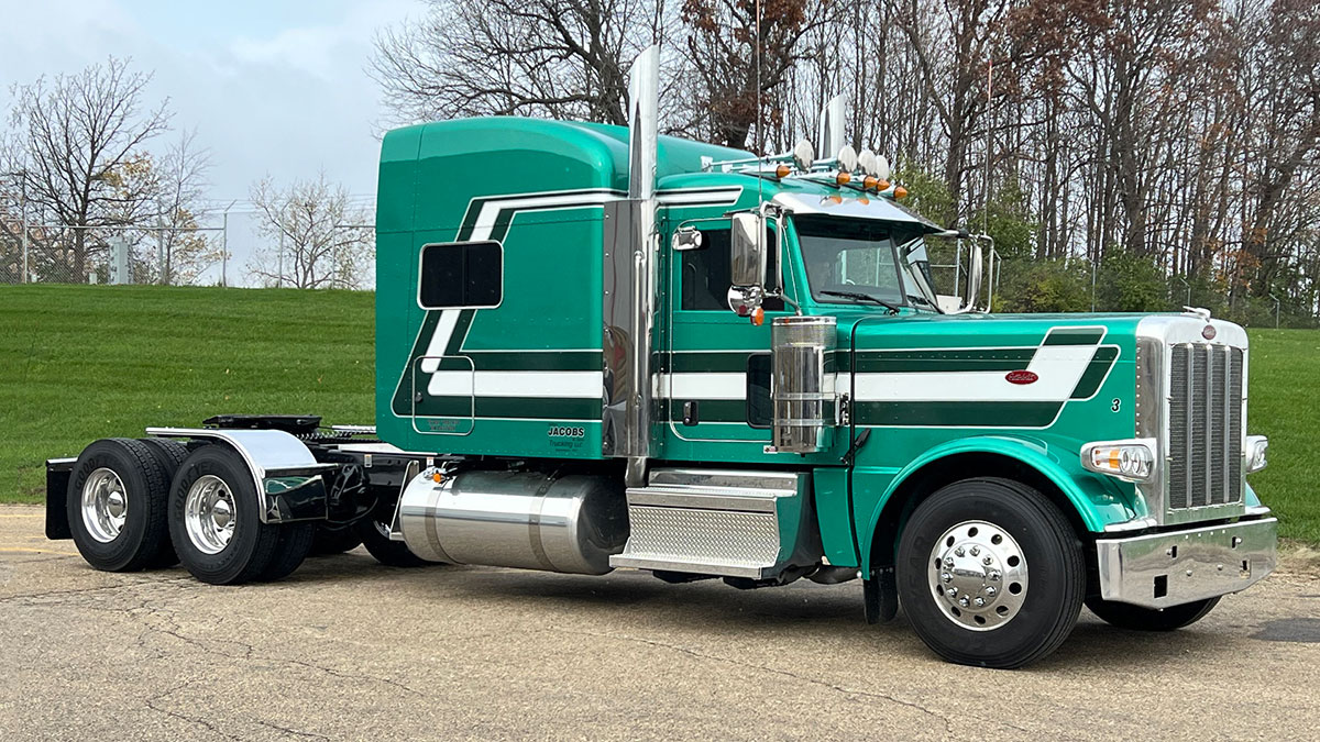 JX Graphics on metallic teal Peterbilt for Jacobs with dark green & white striping