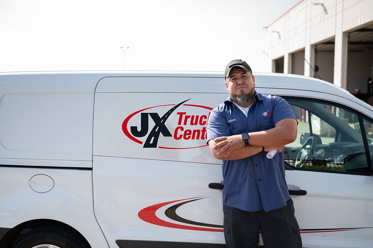 Moises standing in front of Parts Delivery Van