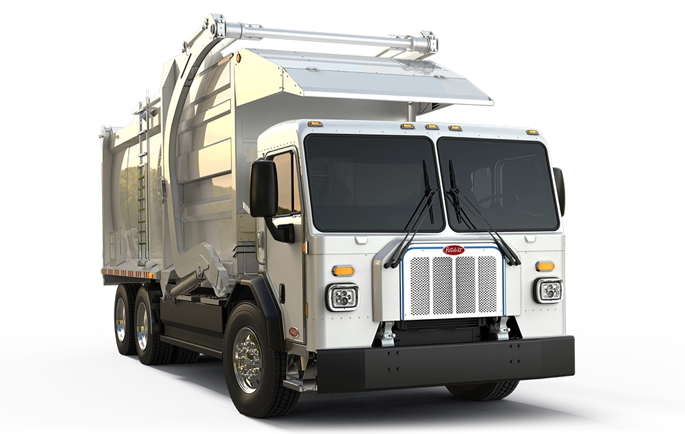 Used Peterbilt 520EV urban street refuse truck profile view