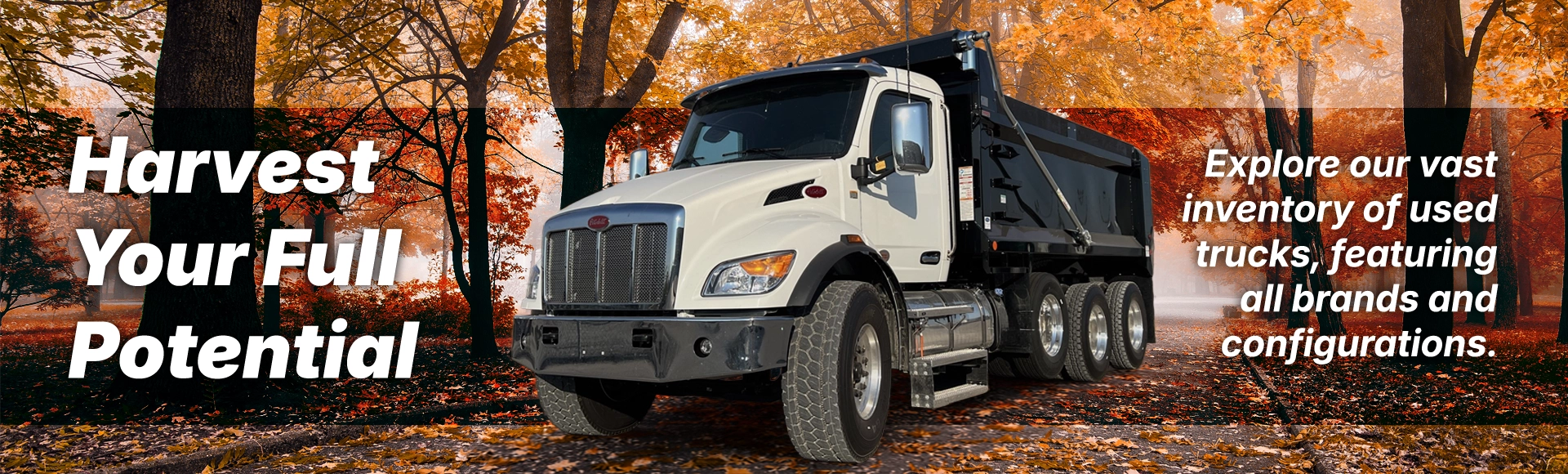 White Peterbilt dump truck surrounded by autumn foliage with text overlay reading Harvest Your Fleet's Full Potential and promoting used trucks across all brands.