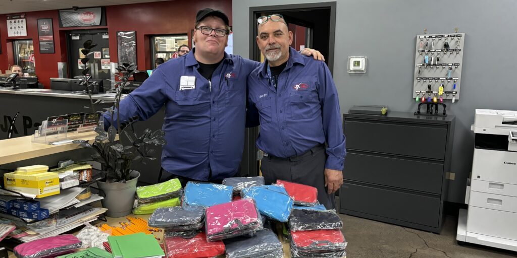 Elmhurst 2 Elmhurst JX Employees with their school supplies donation haul
